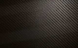 Carbon Golden Hour — dark black carbon fibre background