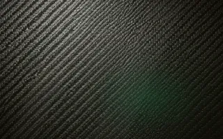 Carbon Warm Studio — dark green and black carbon fibre background