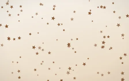Cocoa Stars — light brown, orange and white celestial background