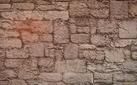 Stonewall Rim Light — dark orange, red and beige stone wall background